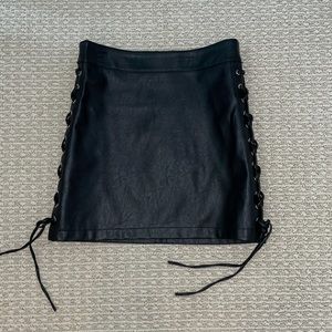 Black pleather skirt with side ties. Size small